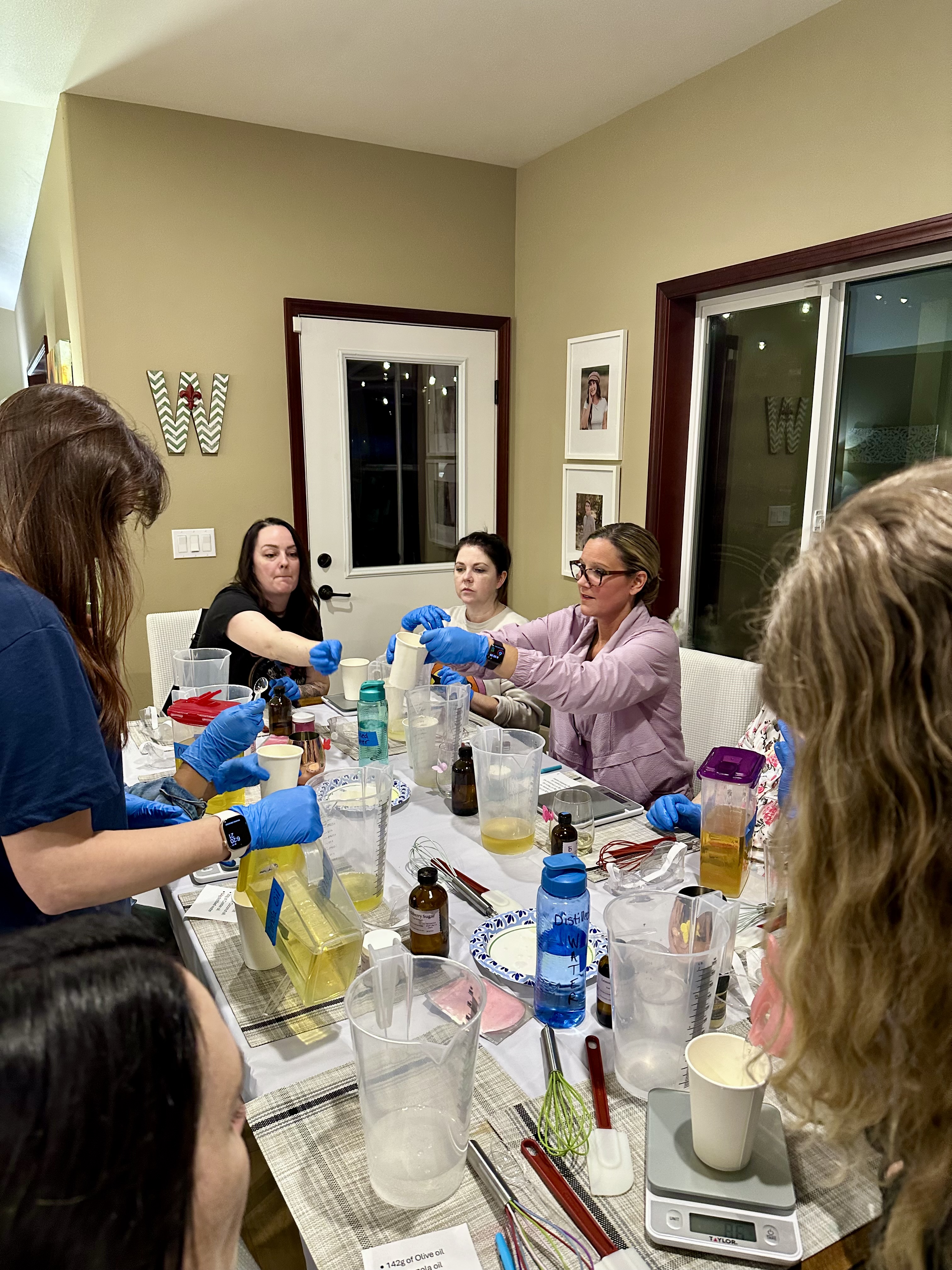 Friends laughing while swirling colors into their soap