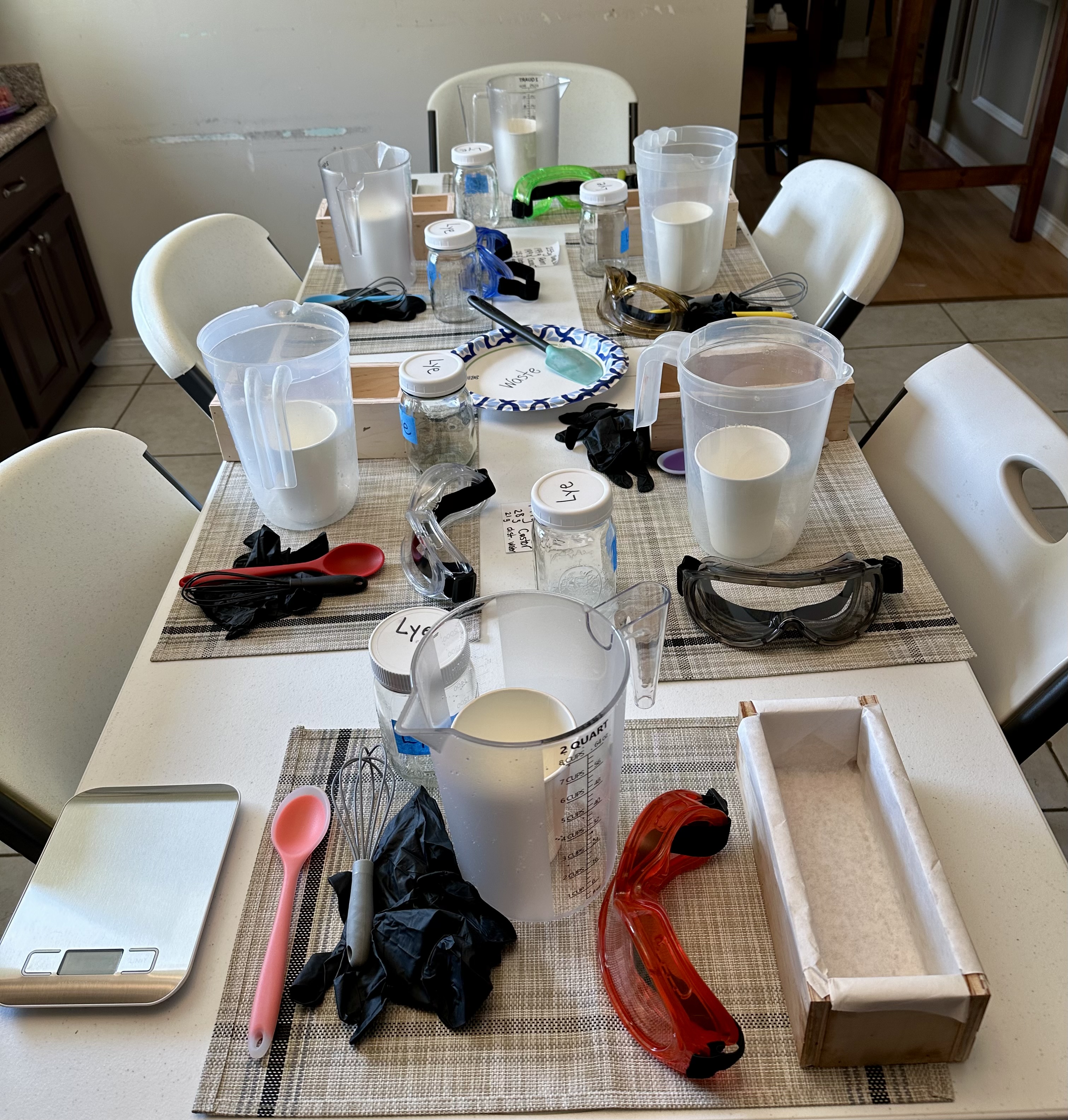 Workshop table set with molds, scales and fragrance oils